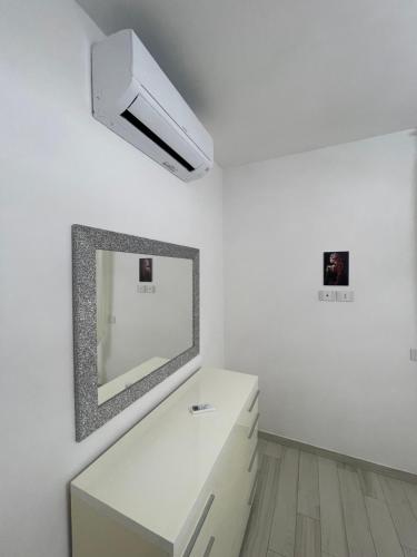 a white room with a mirror and a white dresser at Appartamento Lindo e Dora - A due passi dal mare in San Benedetto del Tronto