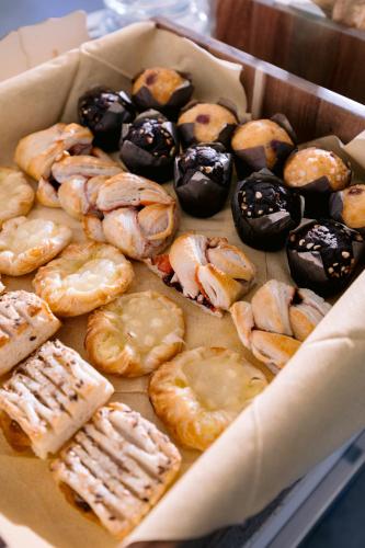 a box of different types of donuts on a table at Hotel Villa Paradiso in Taormina