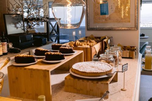 a buffet with cakes and other desserts on tables at Hotel Villa Paradiso in Taormina