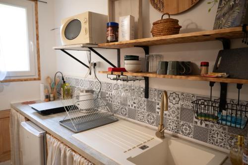 a kitchen with a sink and a counter top at Les gardiens de la vallée in Figeac