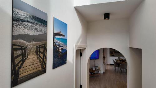a hallway with two paintings on the wall at Villa Talya in Peyia