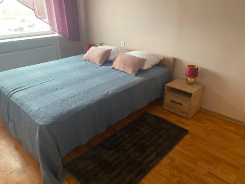a bed with two pillows on it in a bedroom at Suuresilla in Kuressaare