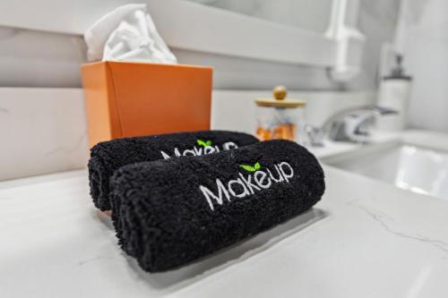 a black towel on a counter next to a sink at Lakefront Beach House - Sauna & Steam Pod Retreat in Ashtabula