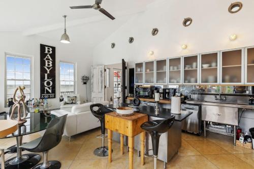 a large kitchen with black chairs and a table at Lakefront Beach House - Sauna & Steam Pod Retreat in Ashtabula