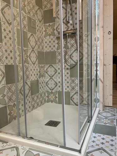 a room with a glass wall with a tile wall at Le Moline b&b in Masserano