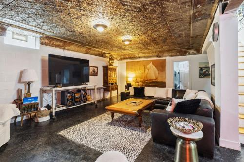a living room with a couch and a table at Lakefront Beach House - Sauna & Steam Pod Retreat in Ashtabula