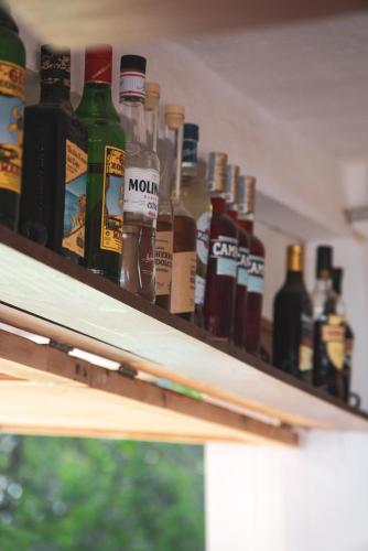 a row of bottles of alcohol on a shelf at Agroturismo Binissafullet Vell in Sant Lluis