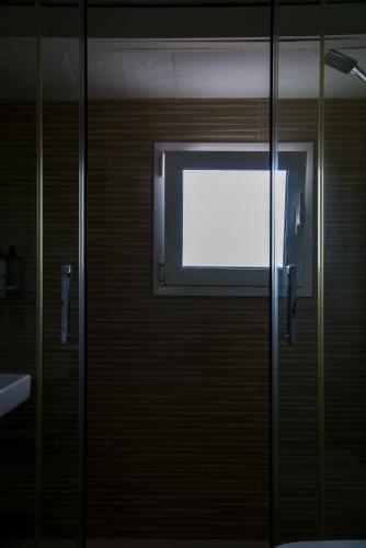 a glass door with a window in a bathroom at Agroturismo Binissafullet Vell in Sant Lluis