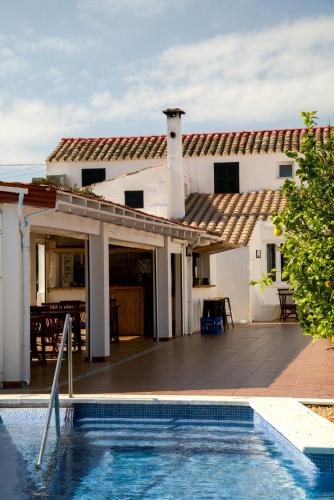 a house with a swimming pool in front of a house at Agroturismo Binissafullet Vell in Sant Lluis