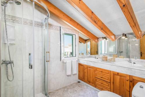a bathroom with a shower and a sink at Villa Sofia in Cala en Forcat