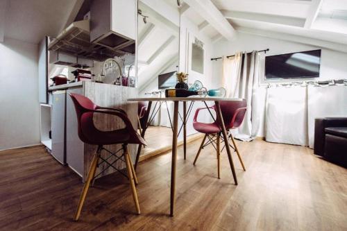 une cuisine avec une table et des chaises dans une pièce dans l'établissement Summer Me - Corfu Downtown Studios, à Corfou