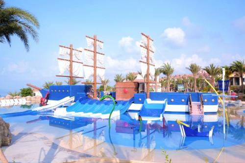 a water park with blue chairs and a pirate ship at Centara Mirage Resort Mui Ne in Mui Ne