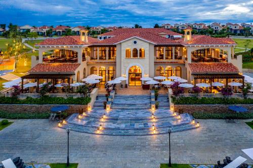 a large house with lights in front of it at Centara Mirage Resort Mui Ne in Mui Ne