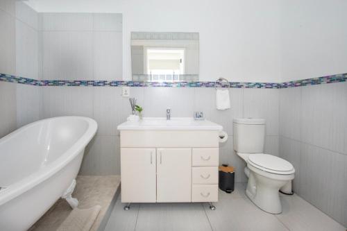 Un baño con bañera, inodoro y lavabo. en Luxury Seaside Apartment, en St Francis Bay