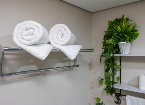 a pair of towels on a towel rack in a bathroom at R2N Cosy Haven - BE Residences Lahug near IT Park Cebu in Cebu City