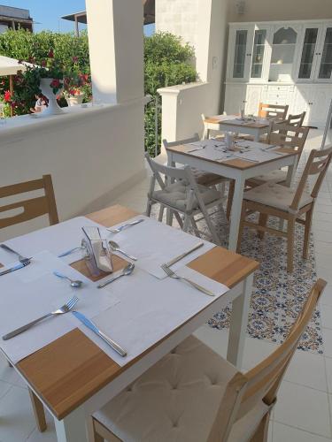 a group of tables and chairs on a patio at B&B Palma Salentina in Lizzano