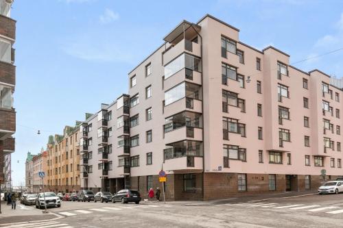 a large pink building on a city street at Cozy Studio in City Centre in Helsinki