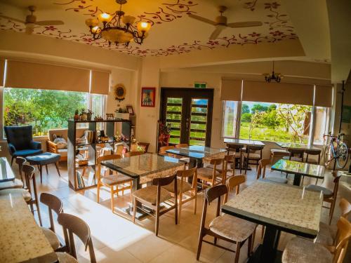 a restaurant with tables and chairs and windows at Mei Jung B&B in Zhixue