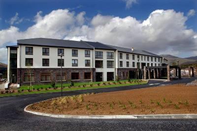 a large white building on the side of a road at Sneem Hotel in Sneem