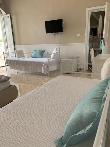 a bedroom with a bed and a tv on the wall at B&B Palma Salentina in Lizzano