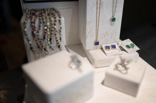a white table with a necklace and other items on it at Meg Lifestyle Hotel & Apartaments in Riccione