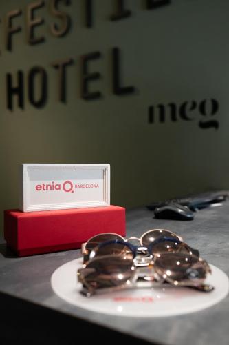 a plate of chocolate covered donuts next to a red box at Meg Lifestyle Hotel & Apartaments in Riccione