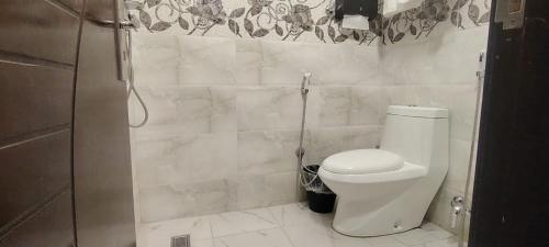 a small bathroom with a toilet and a shower at Dorm Story For Hotel Apartment in Taif