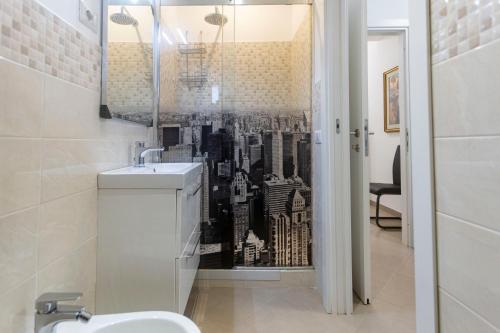 a bathroom with a wall mural of a city at Casa di Patrizia in Rome