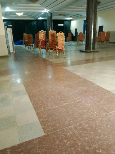 a group of chairs sitting in a large room at Omni Grand Hotel and conference center jabi abuja in Abuja