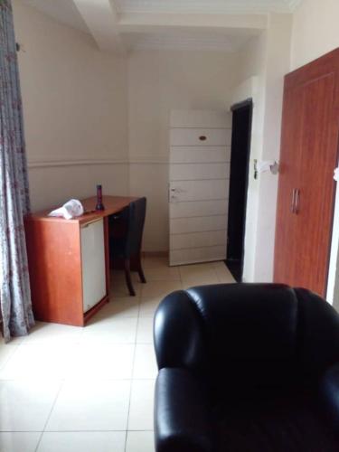 a living room with a desk and a chair at Omni Grand Hotel and conference center jabi abuja in Abuja