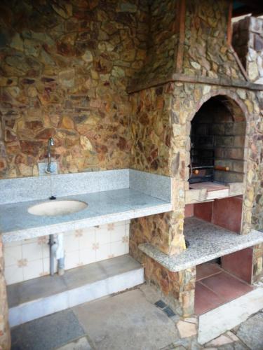 a stone bathroom with a sink and a stone oven at Quinta das AVES - Apartamento T2 com Piscina Comum in Odiáxere