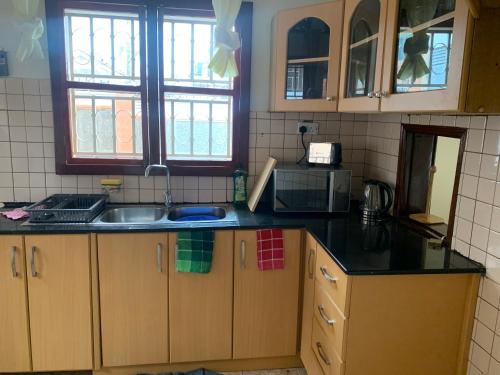 a kitchen with a sink and a counter top at Your Home Away From Home in Kampala