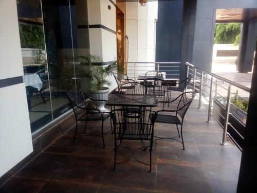 a group of tables and chairs on a balcony at Omni Grand Hotel and conference center jabi abuja in Abuja