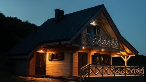 a house with lights on the front of it at Jutrzenka in Międzybrodzie Kobiernickie