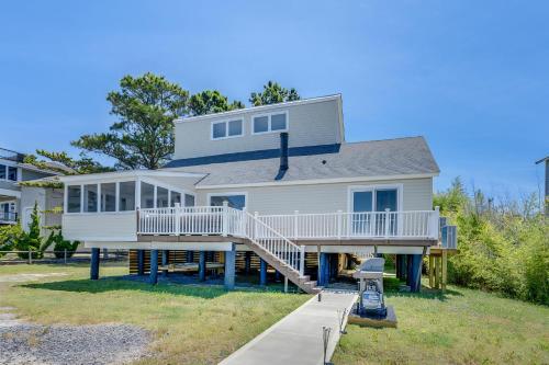 a large white house with a deck and stairs at Shell Shack in Deep Hole