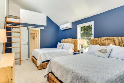 a blue bedroom with two beds and a desk at Shell Shack in Deep Hole