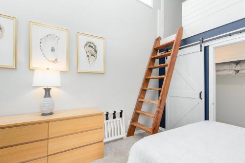 a bedroom with a ladder next to a bunk bed at Shell Shack in Deep Hole