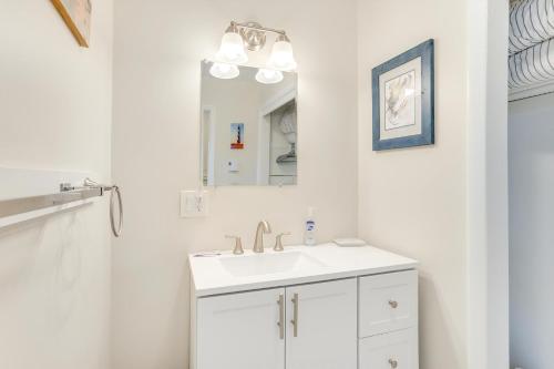 a white bathroom with a sink and a mirror at Shell Shack in Deep Hole