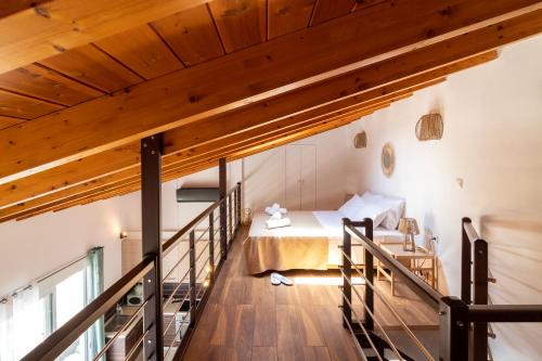 a loft bedroom with a bed and a staircase at Chris Luxury Loft in Kallithea Halkidikis