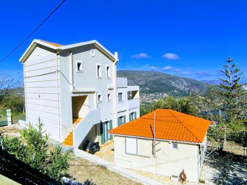 a white house with an orange roof at Villa Sofia with an amazing view in Angón