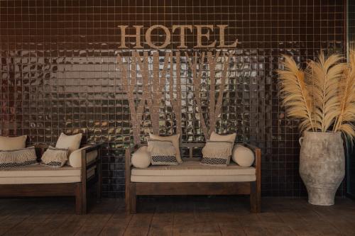 a room with two chairs and a sign on a wall at Hotel Leiriartem by Grupo Quinta dos Lagos in Leiria
