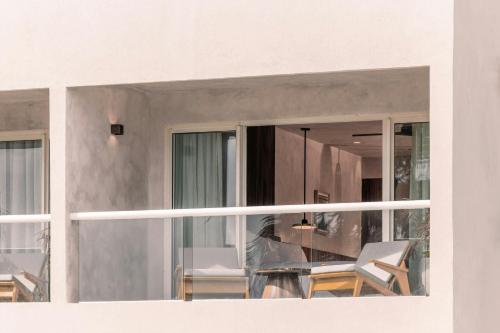 a balcony with two chairs and a table at Almare, a Luxury Collection Resort, Isla Mujeres, Adult All-Inclusive in Isla Mujeres