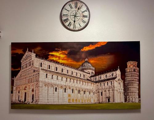 a picture of a building with a clock on the wall at Luna Guest House in Pisa