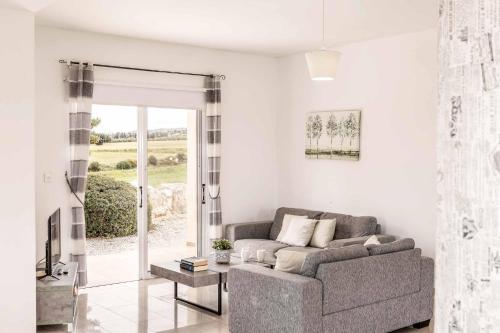a living room with a couch and a window at Villa Lime Tree in Lachi