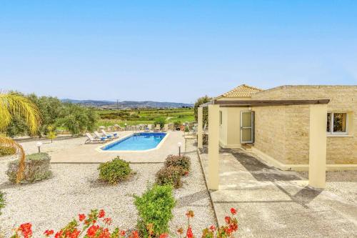 a villa with a swimming pool and a house at Villa Lime Tree in Lachi