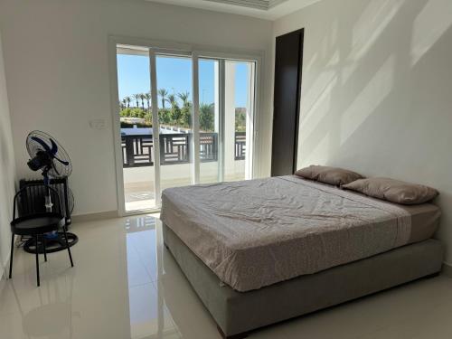 a bedroom with a bed and a large window at 2 Bedroom Apartment for Families in Saidia 