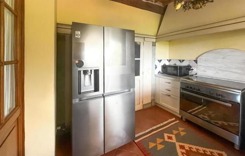 a kitchen with a large stainless steel refrigerator at Beautiful Home In Rapolano Terme Si in Rigomagno