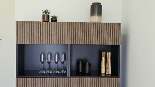 a wooden shelf with silver utensils on it at GuestReady - Seaview Villa with Private Pool in Bretanha