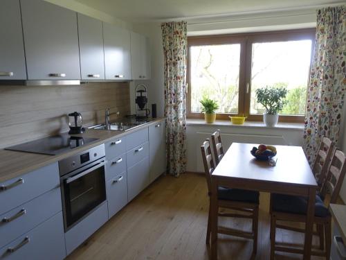 a kitchen with a table and a dining room at Ferienwohnung Mit Garten Im Schönen Tannheim in Tannheim