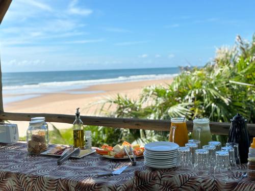 a table with food and a view of the beach at Casa Del Mar in Marau